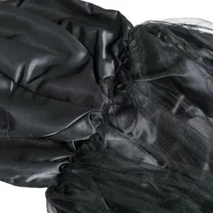 Black satin and mesh fabric close up for Halloween cosplay costume, smooth texture.