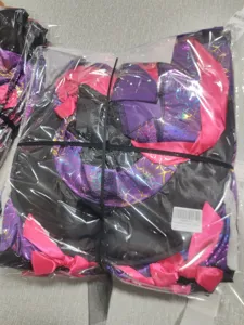 Detailed view of the purple spiderweb witch costume fabric quality and lovely bow decoration.