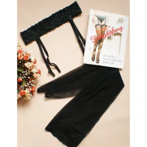 Black lace garter belt and fishnet stockings detail view, featuring elastic straps and elegant packaging.