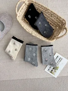 Women cute floral embroidered combed cotton mid-calf socks with sweet bubble cuff design.