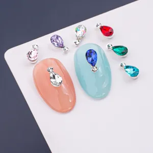 Close-up detail of colorful teardrop double-drill nail art rhinestones with shiny silver alloy base.