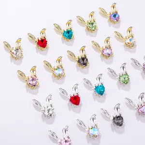Detailed view of cute metal rabbit ear rhinestone nail art charms in assorted colors.