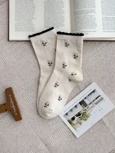 Cute cotton mid-tube socks featuring pink tulip embroidery and black ruffled cuffs.