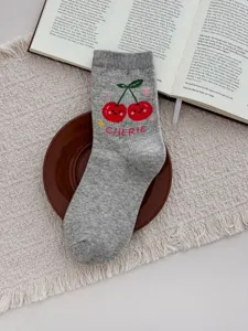 Grey cotton mid-tube socks featuring cute red cherry knit pattern and stylish CHERIE detail.