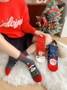 Detailed view of cozy Christmas cotton socks with festive Santa and cute holiday winter designs.