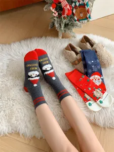 Detail view of Christmas cotton socks with festive cartoon prints, cozy winter style.