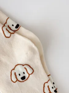 Close-up detail of cute puppy pattern combed cotton socks, soft texture and cozy fabric.