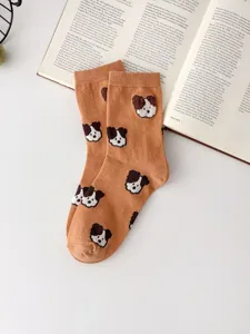 Detail view of cute dog pattern cotton crew socks, cozy fall winter wear, preppy style.