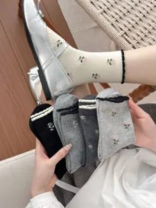 Detail shot of women's floral mid-tube socks featuring bubble cuffs and comfortable combed cotton.