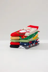 Christmas mid-tube socks featuring cute cartoon Santa Claus and festive winter patterns.