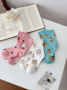 Detailed view of cute cotton socks featuring adorable bear and dessert patterns for women.