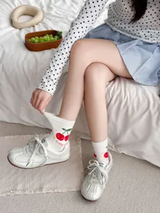 Cute cherry pattern detail on white cotton mid-tube socks, perfect for daily sweet casual wear.