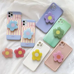Detailed view of colorful irregular flower epoxy phone grip socket and matching cases.