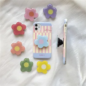 Detail view of Korean ins style irregular flower epoxy resin pop socket and matching plaid phone case.