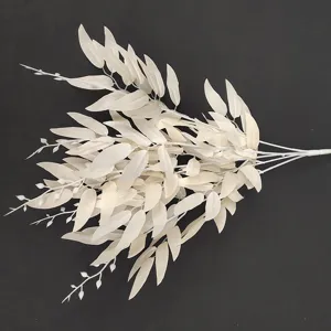 Close-up detail of white artificial willow leaves bundle, perfect for wedding decoration.
