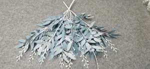 Artificial willow leaf vine detail shot, grey-blue eucalyptus branches for wedding and home decor.