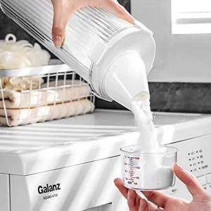 Transparent laundry powder storage container with measuring cup for household organization.