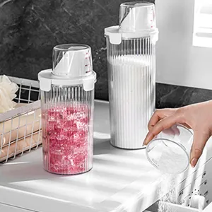 Clear laundry powder storage jar with measuring cup, airtight plastic storage container.