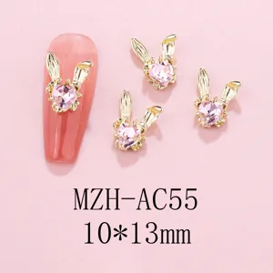 Detailed view of 3D bunny rabbit nail art charms with pink heart rhinestones, alloy gold finish.