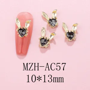 Gold rabbit ear nail charms detail view, black rhinestone metal DIY nail art accessories.