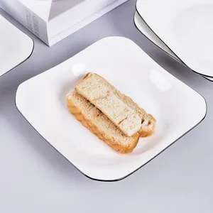 Modern minimalist white ceramic square plate with black rim, elegant tableware for dining.