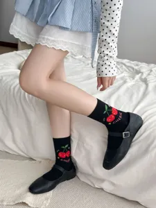 Cute black mid-tube socks for women featuring sweet cherry embroidery and soft combed cotton material.