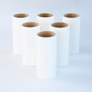 Detailed shot of white tearable lint roller refills, clean paper core surface for pet hair cleaning.