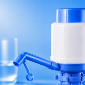 Manual water pump dispenser for bottled drinking water, blue and white design, convenient home.