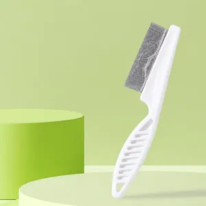 Detalle en primer plano de un peine antipulgas de plástico blanco con finos dientes metálicos.