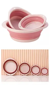Detail view of collapsible pink plastic basins, showing nested and lined up sizes for portable storage.