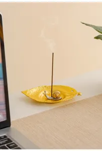 Modern creative metal leaf snail incense burner detail, miniature desktop sandalwood stick holder.