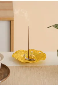 Creative golden lotus leaf snail metal incense burner holder for desktop relaxation decor.