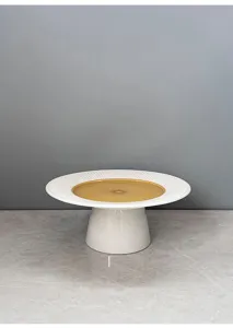 Modern minimalist ceramic cake stand with fluted rim and pedestal base for desserts.