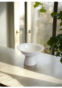 Modern minimalist white ceramic high-footed fruit plate pastry dessert tray for tabletop display.