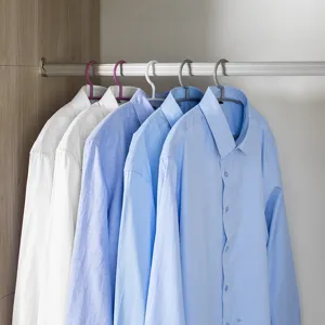 Seamless thin plastic clothes hangers detail view for shirts and straps in wardrobe.