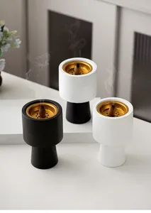 Modern minimalist ceramic incense burner with gold tray for home decor and fragrance.