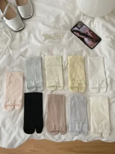 Close-up detail of split-toe socks in various solid colors, soft breathable fabric for daily wear.