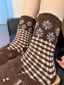 Close-up detail shot of women retro wool knit socks featuring cute floral patterns and grid design.