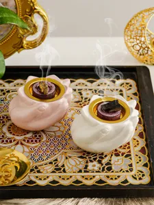 Dettaglio in primo piano del bruciatore d'incenso in ceramica a mano con fumo di sandalo.