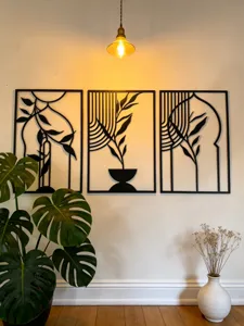 Metal wall art detail showing black iron botanical design, perfect for modern home decor.