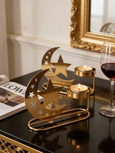 Close-up detail of golden metal star and moon candle holder, elegant home decor accent.