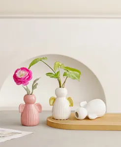 Ceramic angel vase set for home decor, cute desktop floral arrangement ornament, warm aesthetic vibe.