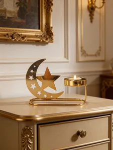 Close-up detail view of a gold metal crescent moon star candle holder home decor.