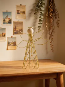 Gold wire angel table sculpture with wood bead head, modern minimalist home decor detail.