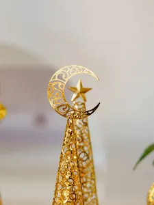 Gold metal hollow Christmas tree candlestick with crescent moon and star for holiday home decor details.