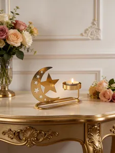 Gold star and crescent candle holder detail shot, elegant holiday table decor with tea light.