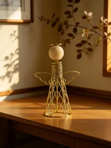 Close-up detail of modern iron and wood angel ornament, elegant line art home desktop decor