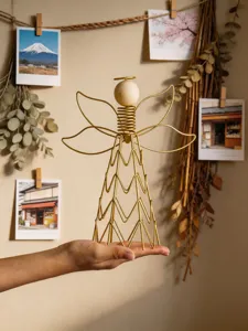 Detailed view of the modern iron wire and wood angel desktop ornament, artistic home decor.