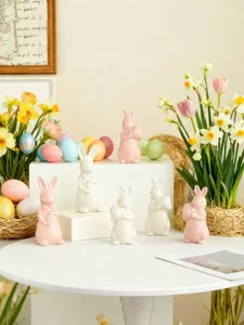 Detailed view of cute ceramic Easter bunny figurines with eggs and spring flowers for decor.