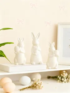 Easter ceramic rabbit figurines set, cute bow tie egg holding bunny for home decor display.